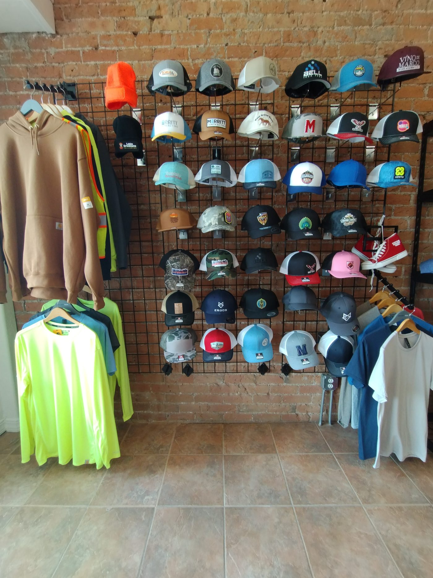 Inside Columbine Copy & Apparel, showing custom hats and apparel on display