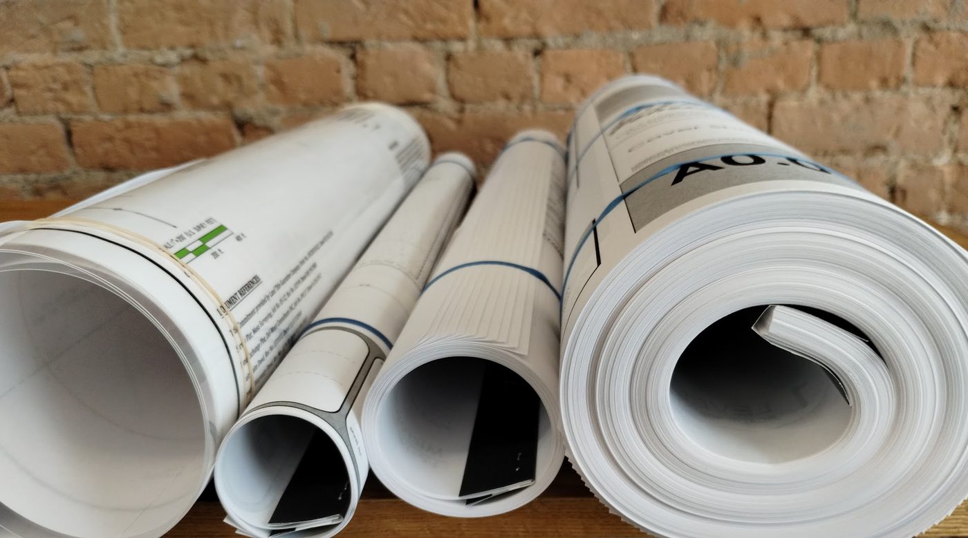 Freshly printed architectural drawings rolled and ready for pickup at Columbine Copy & Apparel