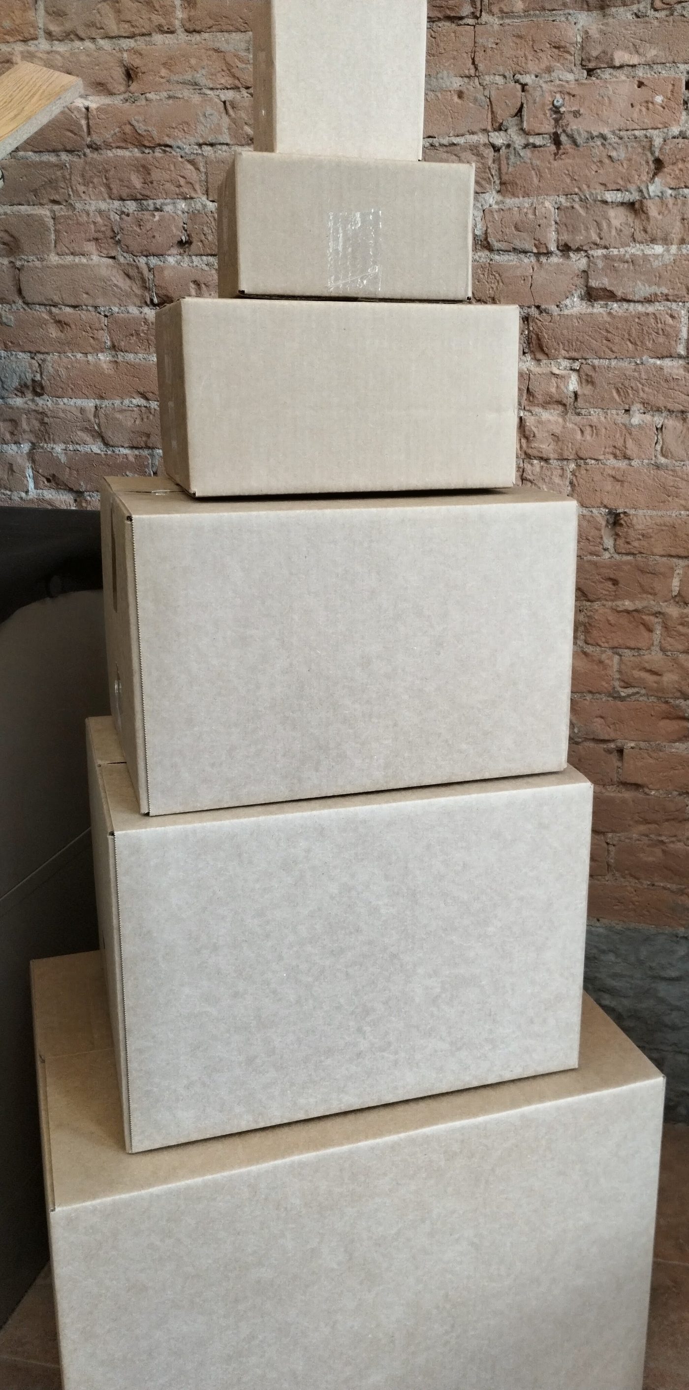 Stack of shipping boxes in multiple sizes available for purchase at Columbine Copy & Apparel