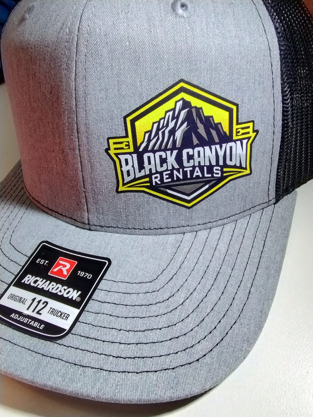 Custom embroidered trucker hat with Black Canyon Rentals logo — custom hats Montrose CO