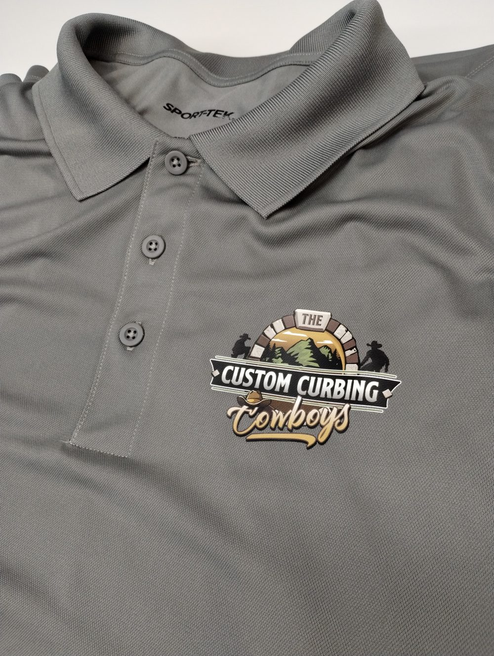 Embroidered polo shirt with Custom Curbing Cowboys logo — custom embroidery Montrose CO